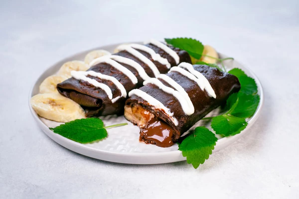 Chocolate crepes with cheese, banana, and nutella